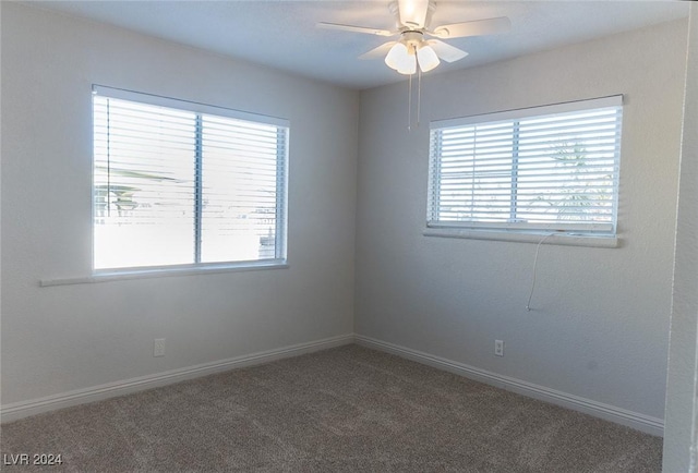 carpeted spare room with a wealth of natural light and ceiling fan