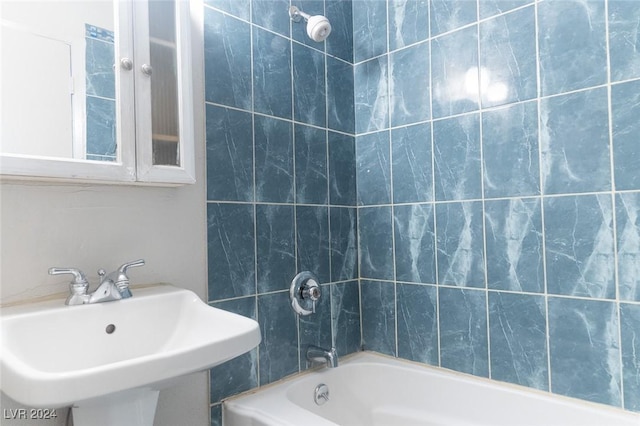 bathroom featuring tub / shower combination and sink