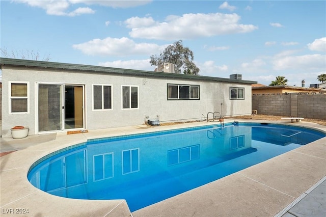 view of pool featuring a patio and central air condition unit