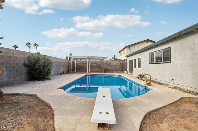 view of pool with a pergola and a diving board