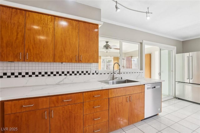 kitchen with sink, backsplash, ornamental molding, light tile patterned floors, and stainless steel appliances