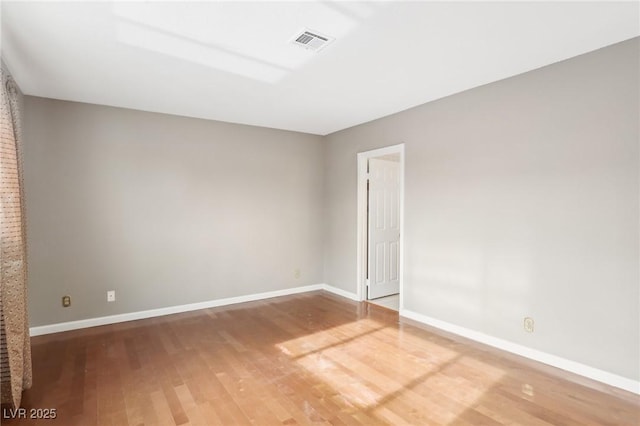 spare room featuring hardwood / wood-style floors