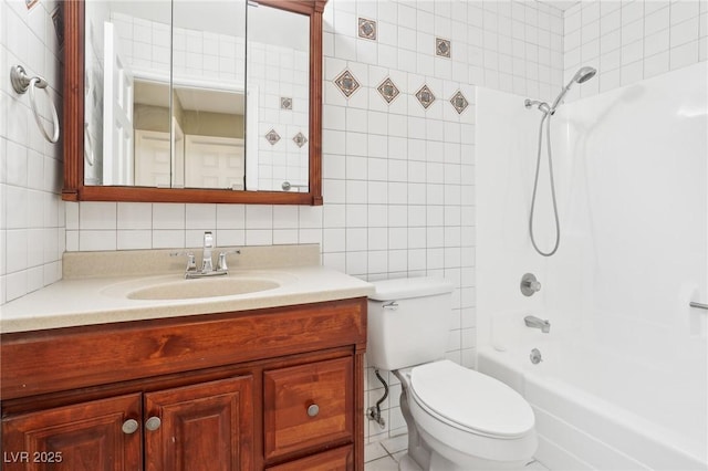 full bathroom with vanity, toilet, tile walls, and shower / tub combination