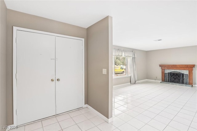 tiled foyer entrance featuring a tile fireplace