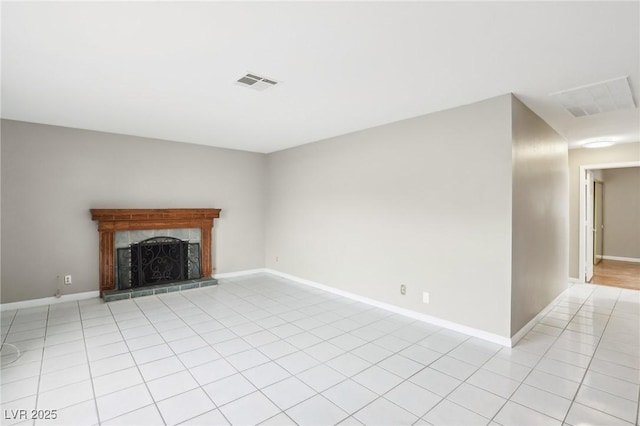 unfurnished living room featuring a tile fireplace and light tile patterned floors