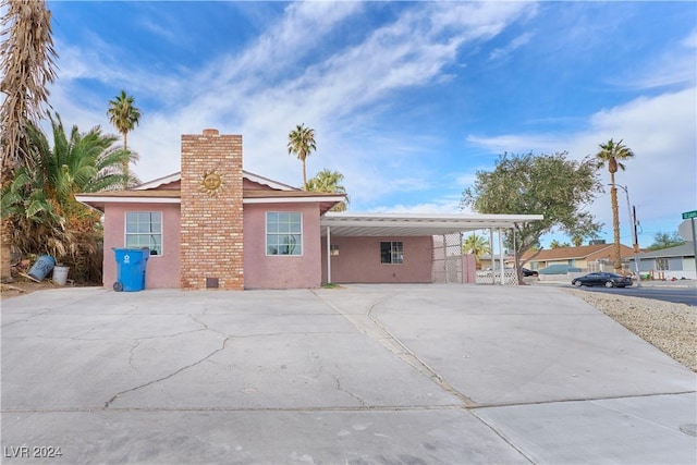 view of front of property featuring a carport