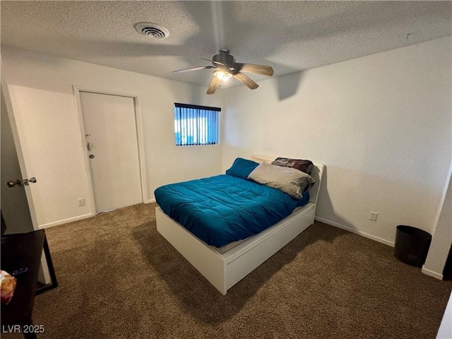 carpeted bedroom featuring visible vents, ceiling fan, a textured ceiling, and baseboards