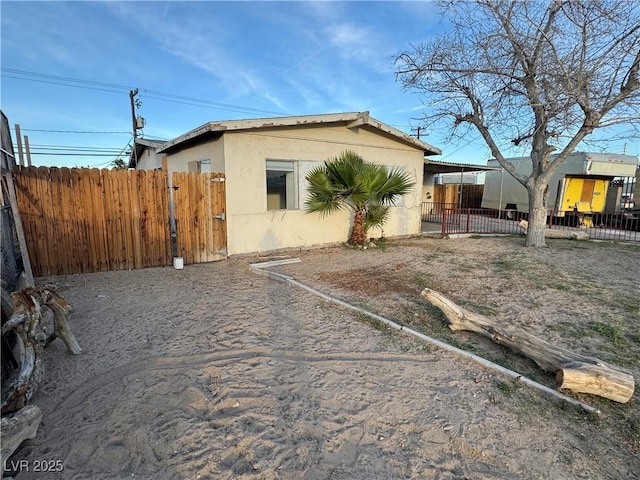 exterior space with fence and stucco siding