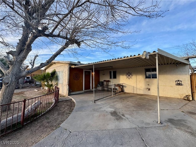 exterior space featuring fence and stucco siding