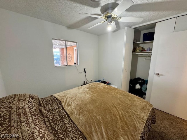 bedroom with carpet, a closet, ceiling fan, and a textured ceiling