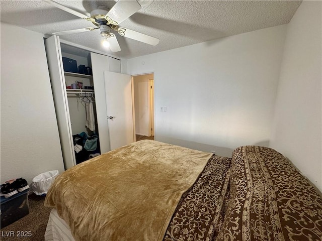 bedroom with a textured ceiling, a closet, and a ceiling fan