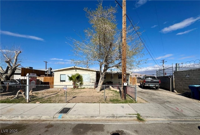 view of front facade featuring a fenced front yard and concrete driveway