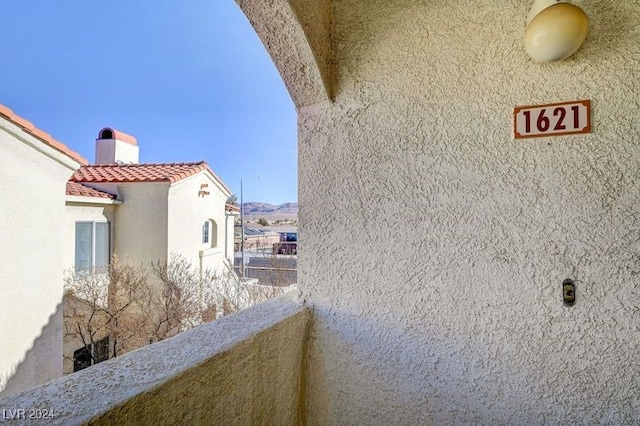 view of side of home featuring a balcony