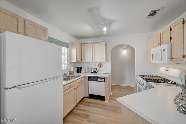 kitchen featuring light brown cabinets, white appliances, light hardwood / wood-style floors, and sink