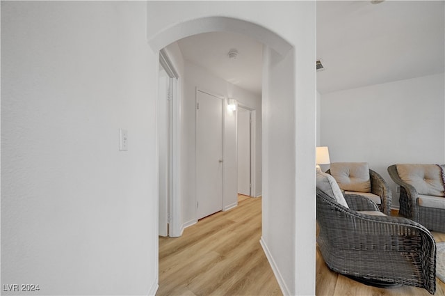 corridor with light hardwood / wood-style flooring