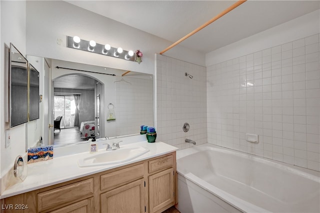 bathroom with vanity and tiled shower / bath combo