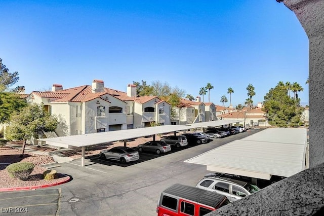 view of parking / parking lot featuring a carport