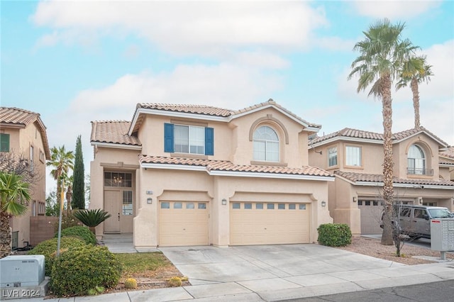 mediterranean / spanish home featuring a garage