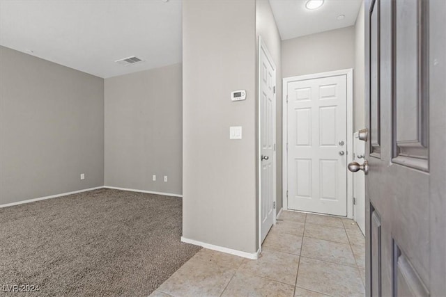 entryway featuring light carpet