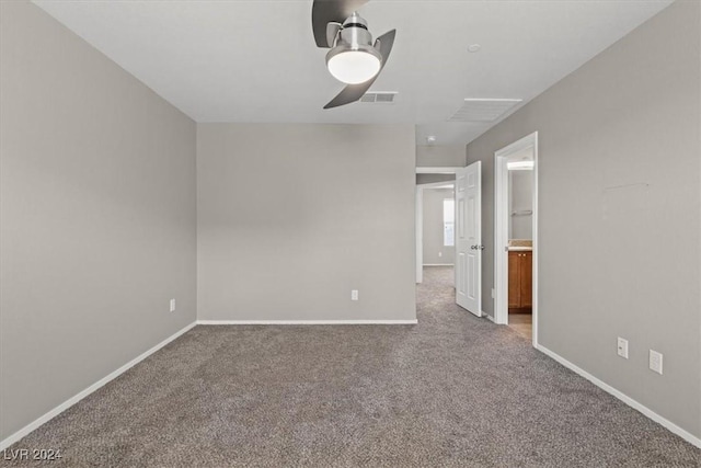 carpeted spare room with ceiling fan