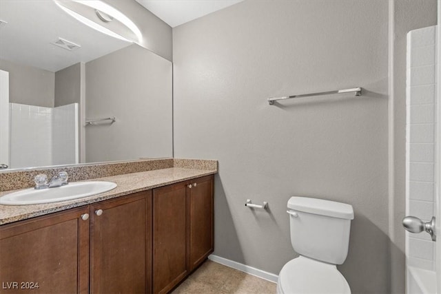 bathroom with a shower, vanity, and toilet