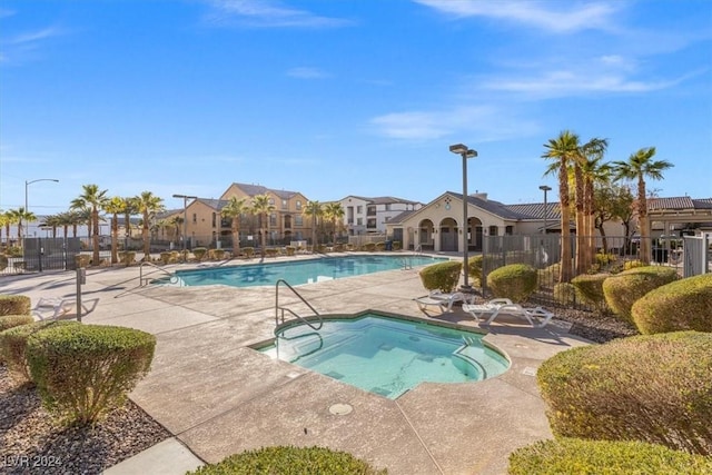 view of pool with a community hot tub and a patio