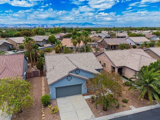 drone / aerial view featuring a residential view and a mountain view