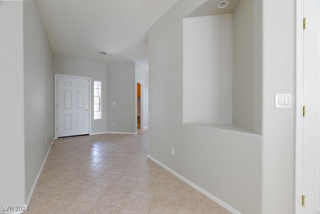 foyer featuring light tile patterned floors, visible vents, and baseboards