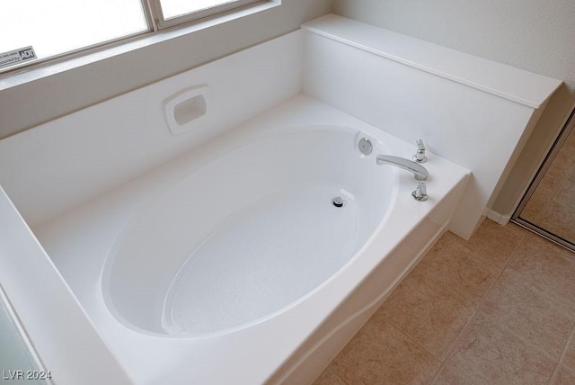 full bath with tile patterned flooring and a bath