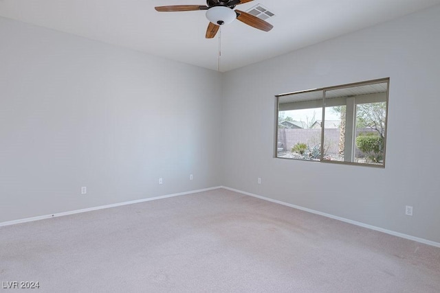 spare room featuring a ceiling fan, carpet flooring, baseboards, and visible vents