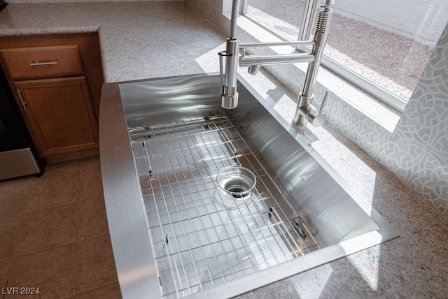 kitchen with brown cabinetry and a sink