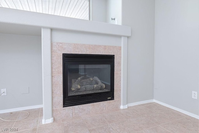 details with baseboards and a tile fireplace