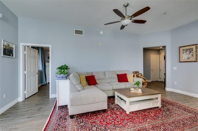 living room with hardwood / wood-style flooring and ceiling fan