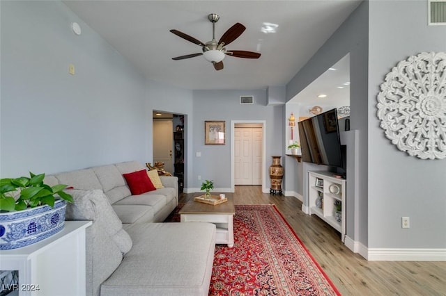 living room with light wood-type flooring and ceiling fan