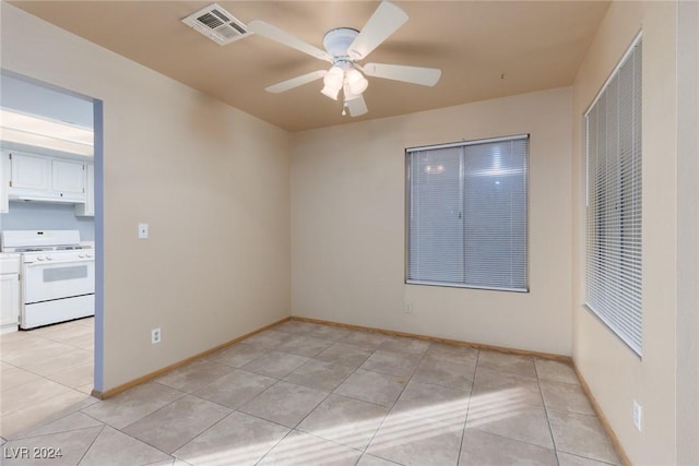 spare room featuring light tile patterned floors and ceiling fan