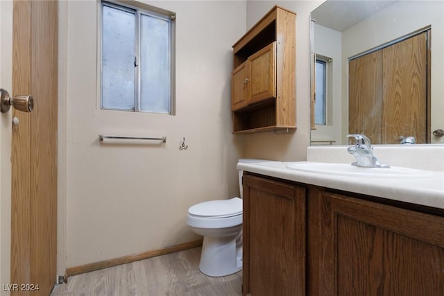 bathroom featuring hardwood / wood-style flooring, vanity, and toilet