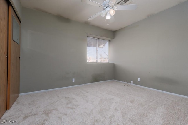 carpeted empty room with ceiling fan