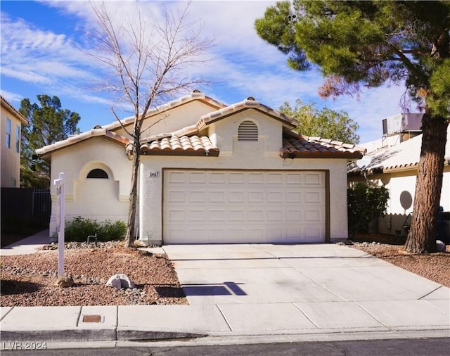 mediterranean / spanish house with a garage