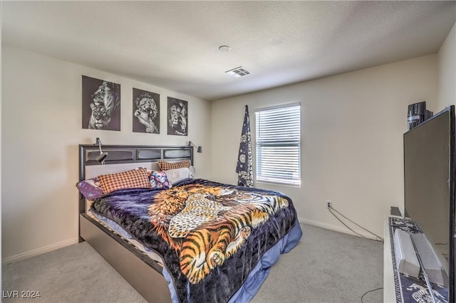 bedroom featuring baseboards, carpet floors, and visible vents