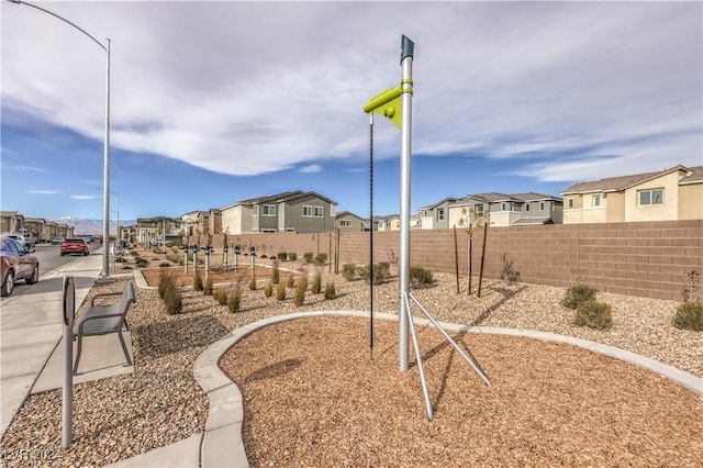 view of home's community featuring a residential view and fence