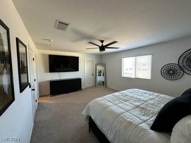 bedroom featuring ceiling fan, carpet, and visible vents