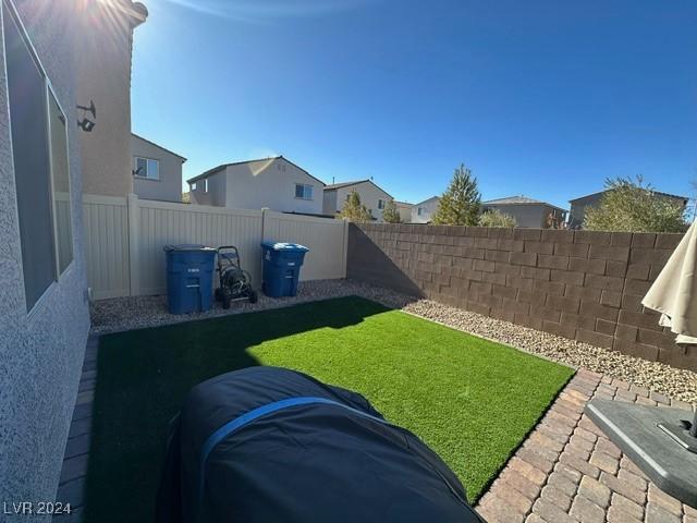 view of yard featuring a fenced backyard and a residential view