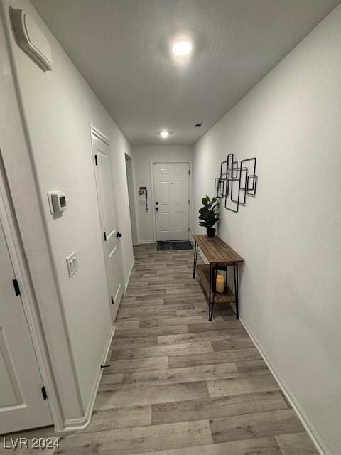 corridor with light hardwood / wood-style flooring