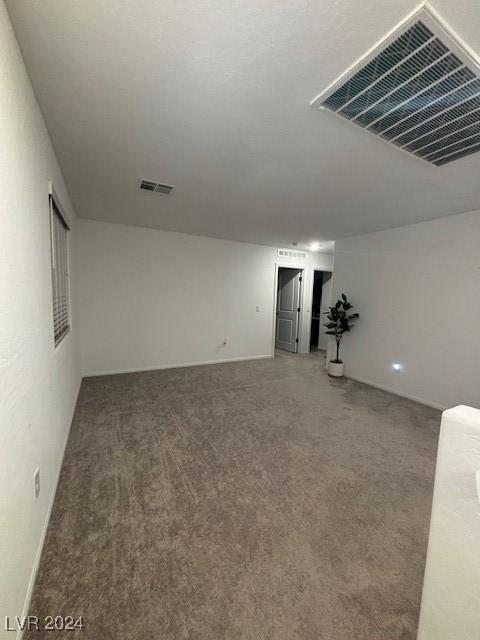 unfurnished room featuring light colored carpet and visible vents