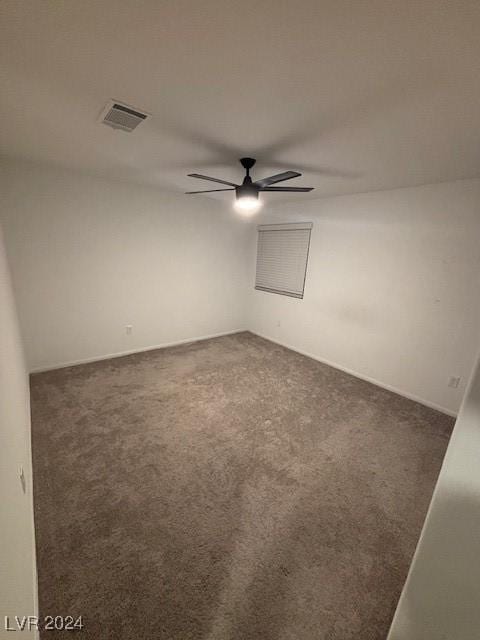 unfurnished room with a ceiling fan, visible vents, and carpet flooring