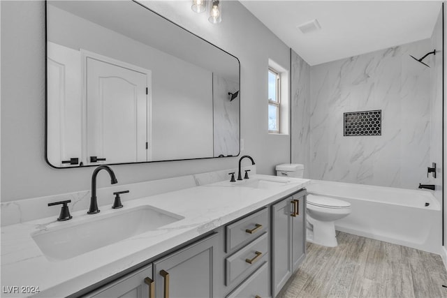 full bathroom with vanity, toilet, and tiled shower / bath