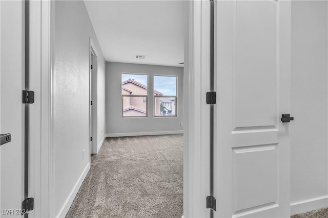 hall featuring light colored carpet