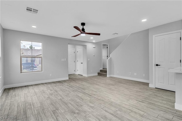 unfurnished living room featuring ceiling fan