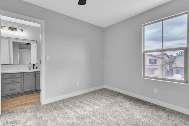 carpeted spare room featuring sink