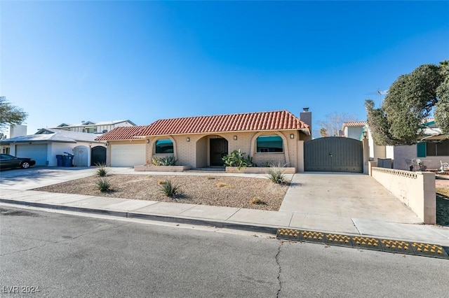 mediterranean / spanish-style house with a garage